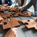 Business People Team Sitting Around Meeting Table And Assembling