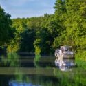 Boat in lush area around Canal du Midi in France.