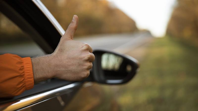 Thumbs up from car.