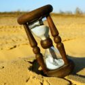 Hourglass on a beach in late afternoon