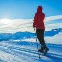 Woman cross country skiing on a mountain.