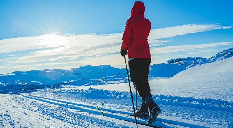 Woman cross country skiing on a mountain.