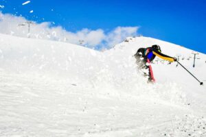 Downhill skier going fast.