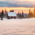 Winter landscape with cottage, deep snow and sunset.